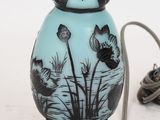 a blue glass vase with a black and white design on it