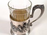 a silver cup with a handle and a handle on it