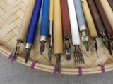 many different colored pens in a basket on the table
