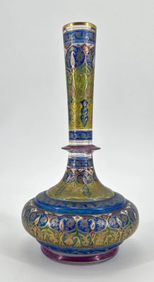 a blue and green vase sitting on a white surface
