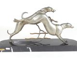 statue of two greyhound dogs running on a black marble base