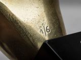 a gold statue of a horse with a number on it ' s head