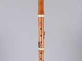 a wooden flute with a black and white design on it