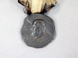 a medal with a ribbon around it that has a picture of a man ' s face on it