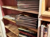 books are stacked on a shelf in a room with pink walls