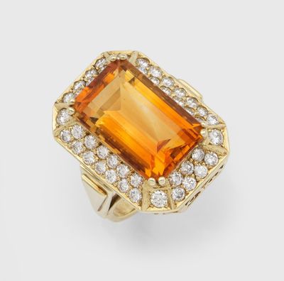 an orange sapphire and diamond ring
