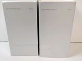 two white boxes sitting next to each other on a white surface