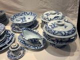 a lot of blue and white plates and bowls on a table
