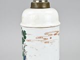 an image of a white and green vase with a bird on it