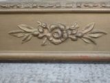 a picture of a gold frame with flowers and leaves on it