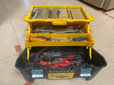 a yellow tool box with tools in it on the floor