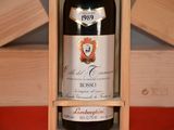 a bottle of wine in a wooden box on a table