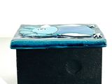 a small black box with a blue design on it