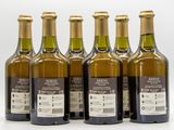 six bottles of wine are lined up in a row on a white surface