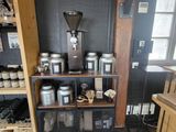 a small coffee shop with a lot of items on the shelves
