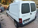 a white van that is parked on the side of the road