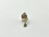 a close up of a small silver key on a white surface