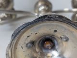 a close up of a silver plate with a metal handle
