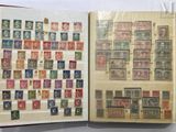 an open book with a lot of stamps on it sitting on top of a table