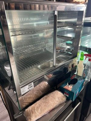 a glass display case with some food inside of it