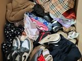 a box full of clothes and shoes in it