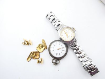 a watch that is laying on a table next to a gold cuff