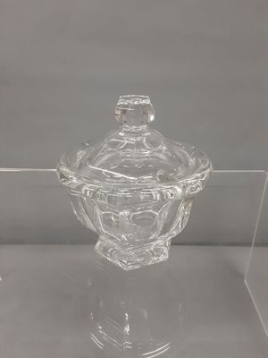 a clear glass jar with a lid sitting on top of a table
