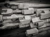 black and white photograph of a pile of bolts and wrenches