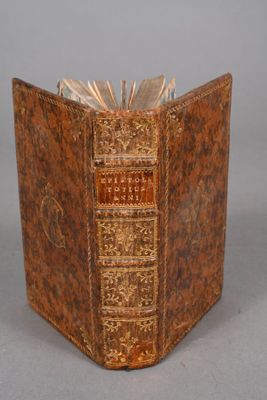 un vieux livre à la couverture brune posé sur une table