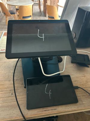 a tablet computer sitting on top of a wooden table
