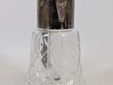 a glass salt and pepper shaker sitting on a table