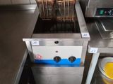 an image of a commercial kitchen with a fryer and a sink