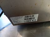 a label on the bottom of a machine on the table