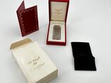 a small box with a watch inside of it on a white surface
