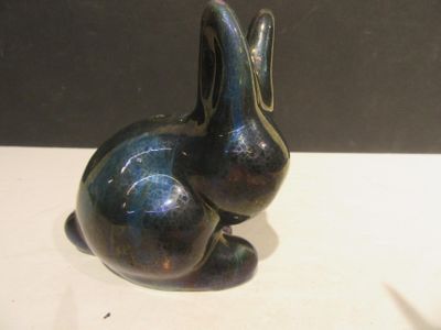 a black rabbit statue sitting on a white table