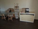 a small desk with a coffee maker on it in the corner of a room