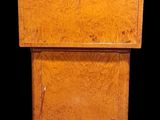 a small wooden cabinet with a drawer underneath it