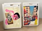 two boxes with pictures of people on them on a table
