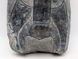an image of a stone sculpture of a face