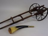 a wooden cart with a horn and a pipe on it