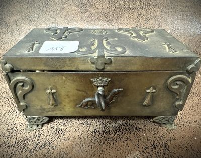 an old metal box sitting on top of a carpet covered floor