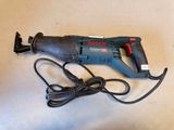 an image of a corded drill is laying on a table