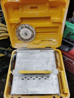a yellow box with a tool in it sitting on the ground