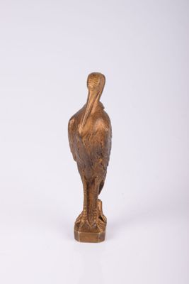 bronze statue of a pelican on a white background