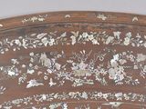 a close up of a wooden headboard with flowers on it