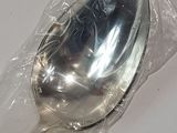 a silver spoon in a plastic bag on a table