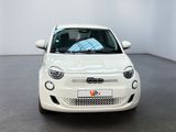 white small car parked in a large room with white walls