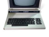 an old computer with a keyboard and monitor on it