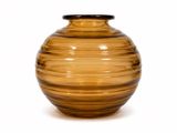 a brown glass vase with a black lid on a white background