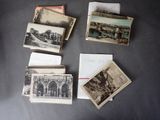many old postcards on a table with a note